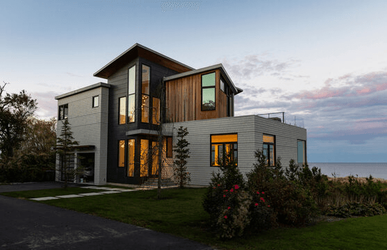 Signing real estate documents beside a small house model